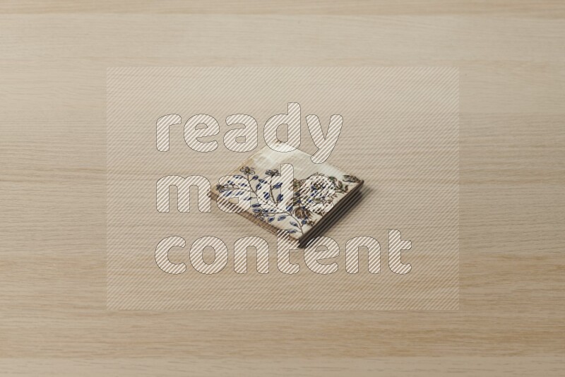 A decorative coaster on light wooden background