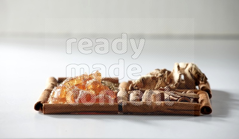 4 squares of cinnamon sticks full of cumin, cinnamon, dried ginger and gum arabic on white flooring