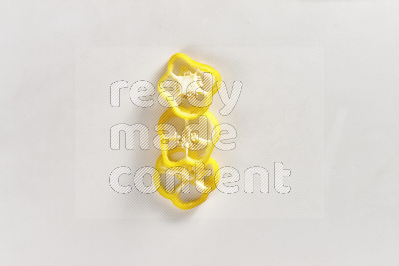 Yellow bell pepper slices on white background