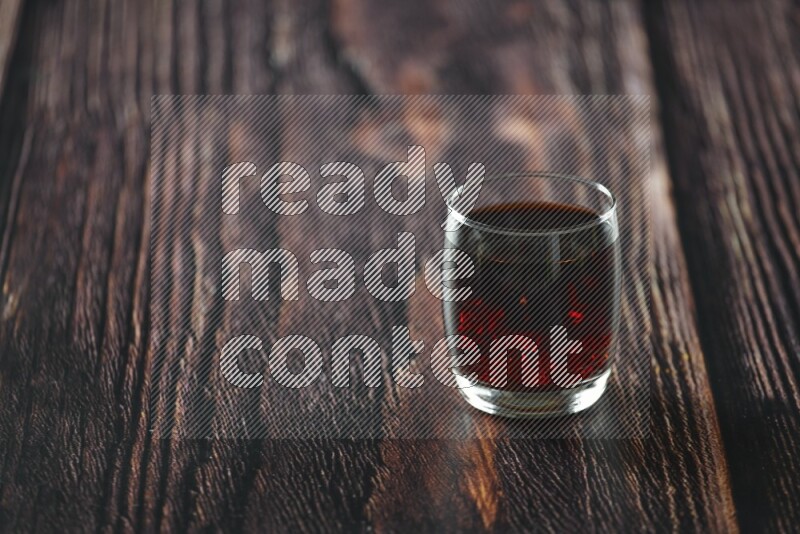 Cold drinks in a glass cup such as water, tamarind, qamar eldin, sobia, milk and hibiscus on wooden background