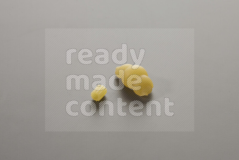 Small rings pasta with other types of pasta on grey background