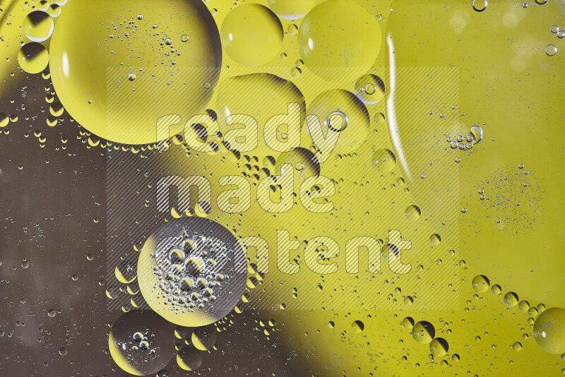 Close-ups of abstract oil bubbles on water surface in shades of yellow and brown