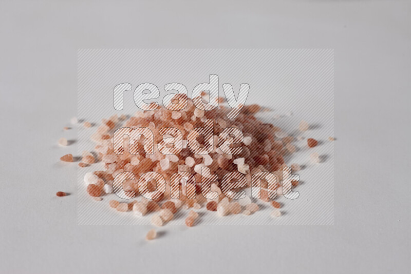 A bunch of coarse himalayan salt crystals on white background