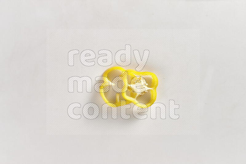 Yellow bell pepper slices on white background