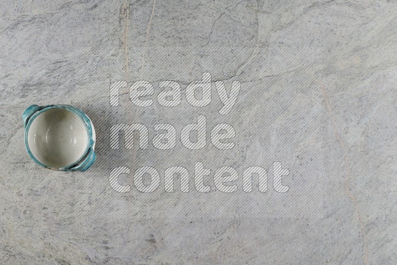 Top View Shot Of A Multicolored Pottery Bowl On Grey Marble Flooring