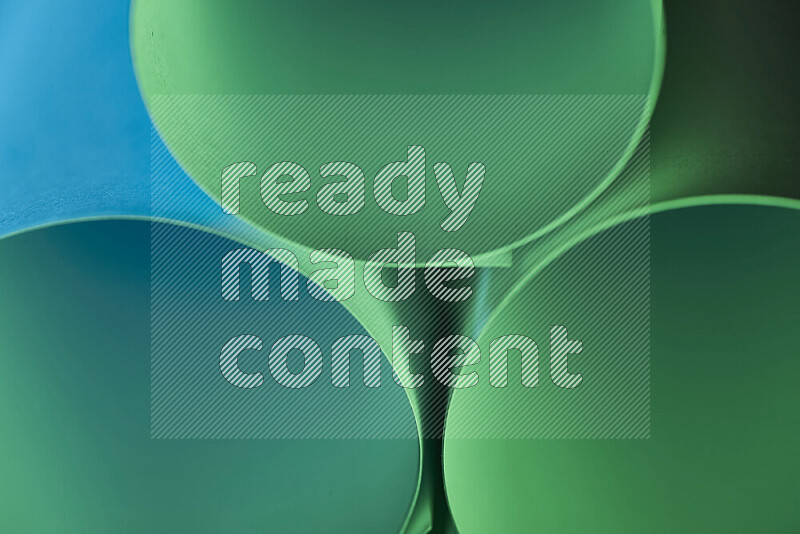 The image shows an abstract paper art with circular shapes in varying shades of green and blue