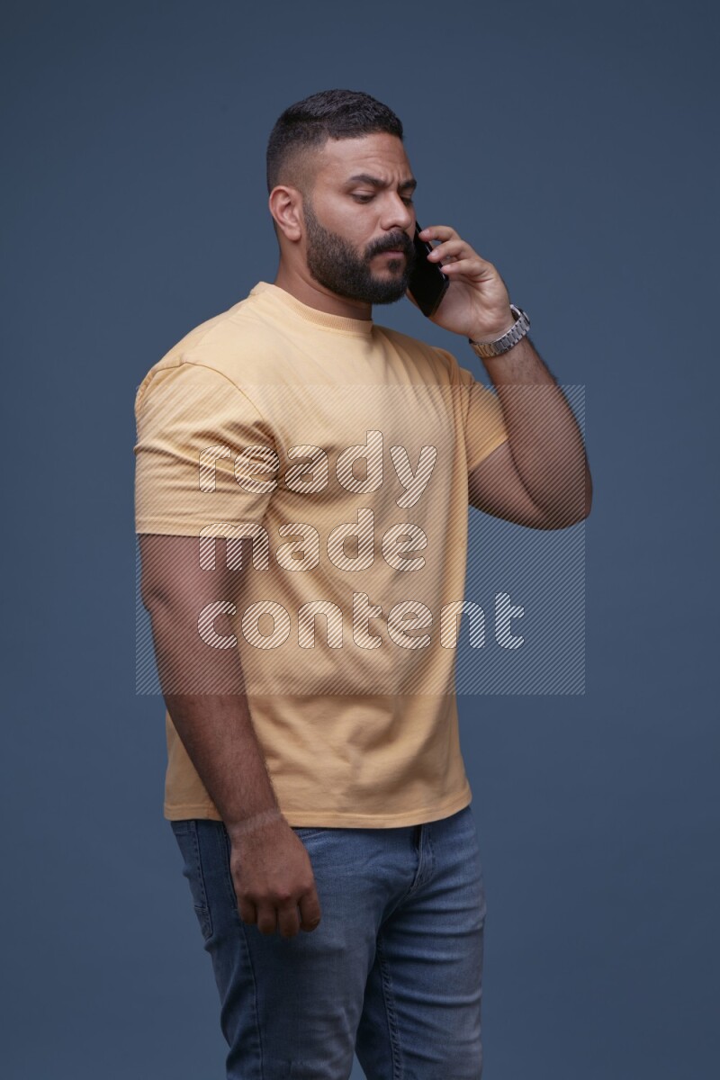 A man Calling on Blue Background wearing Orange T-shirt