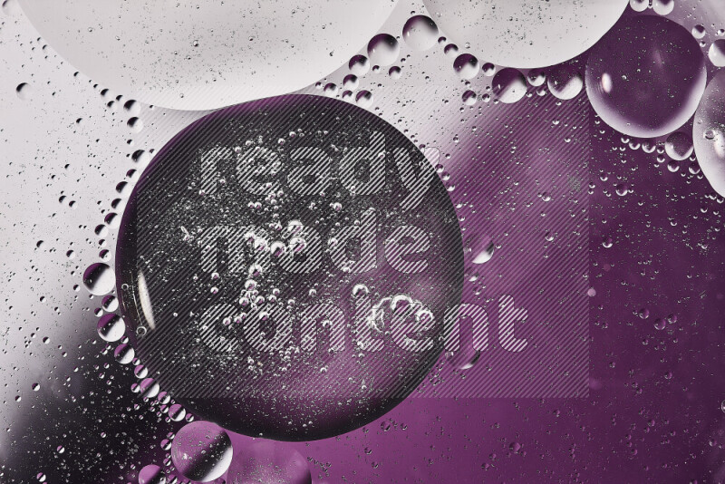 Close-ups of abstract oil bubbles on water surface in shades of white and purple