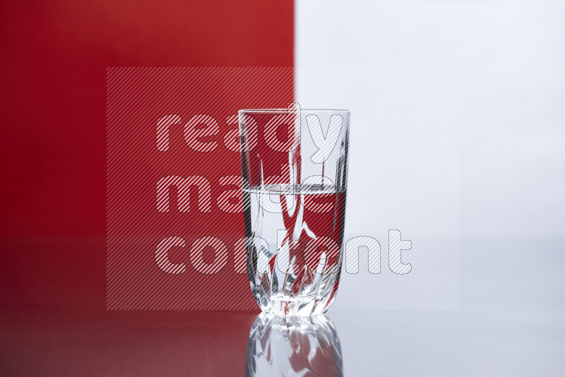 The image features a clear glassware filled with water, set against white and red background