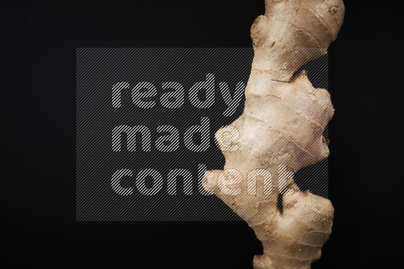 Fresh ginger root on black background