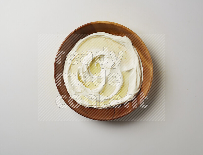 Lebnah garnished with olive oil in a wooden plate on a white background