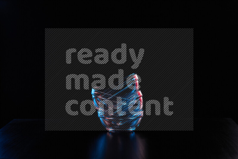 Glassware with rim light in red and blue against black background