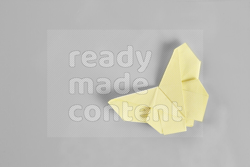 Origami butterfly on grey background