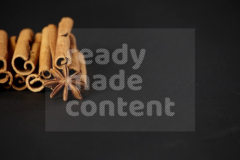 Cinnamon sticks and star anise on a black background