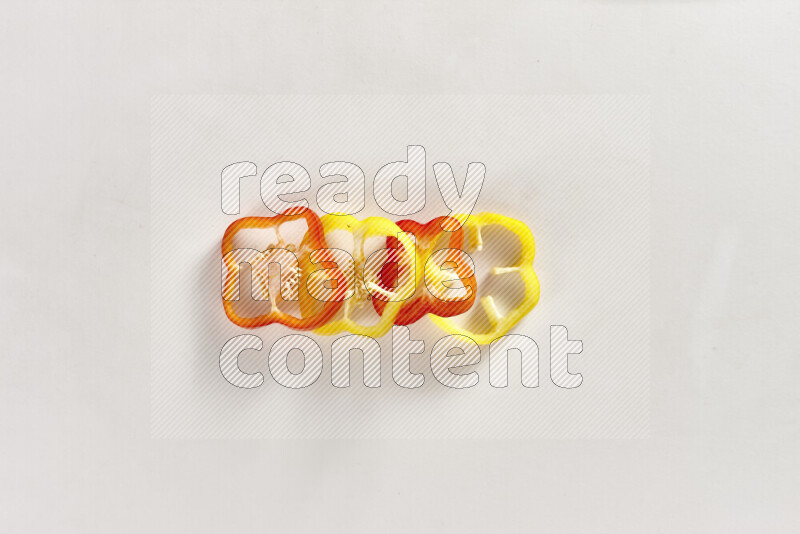 Assorted bell pepper slices on white background