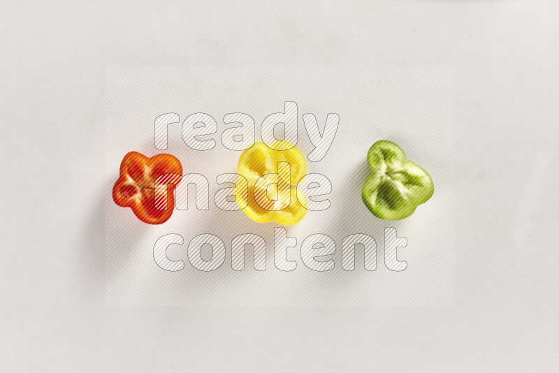 Assorted bell pepper slices on white background