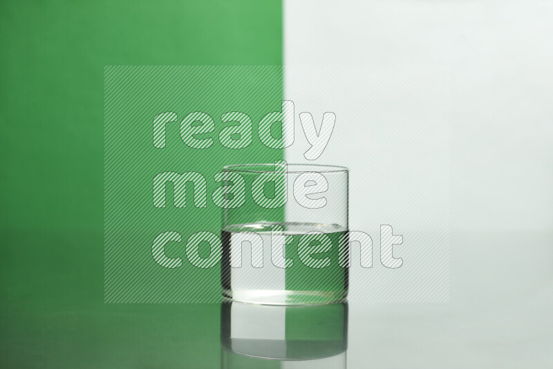 The image features a clear glassware filled with water, set against white and green background