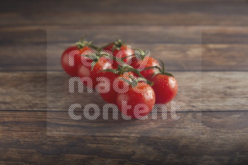 Red cherry tomato vein on a textured wooden background 45 degree