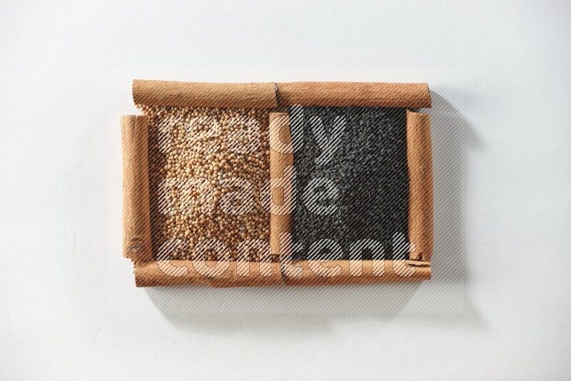 2 squares of cinnamon sticks full of mustard seeds and black seeds on white flooring