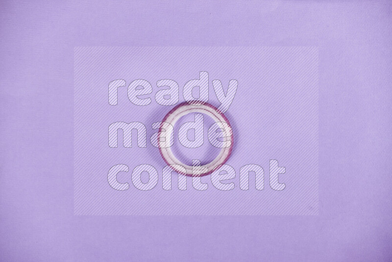 Red onions rings on purple background
