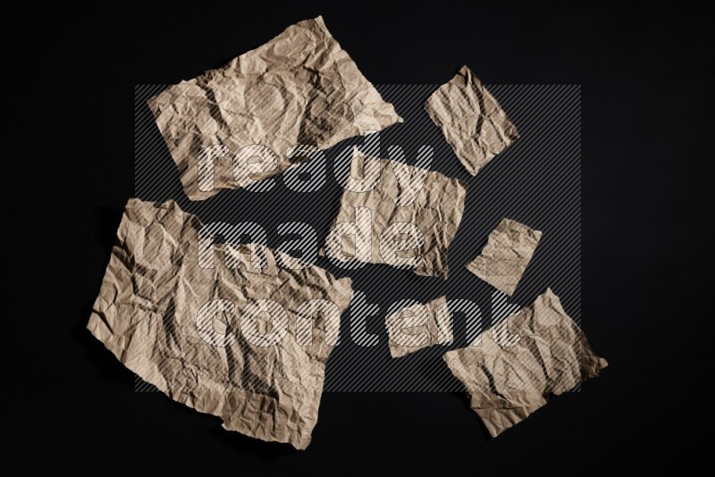 Crumpled craft paper on black background