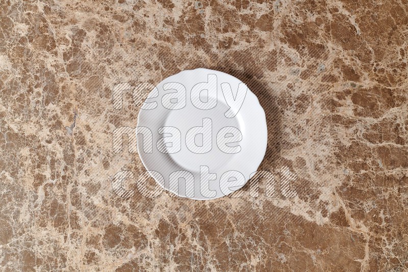 Top View Shot Of A White Ceramic Circular Plate On beige Marble Flooring