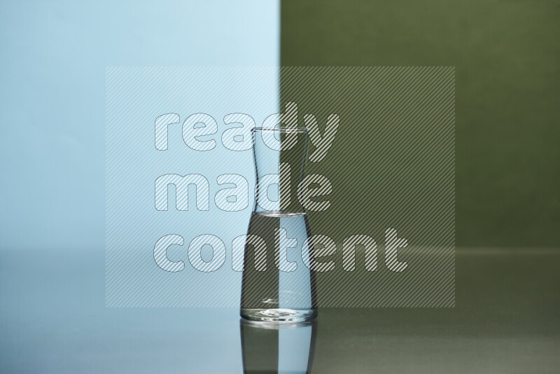 The image features a clear glassware filled with water, set against light blue and dark green background