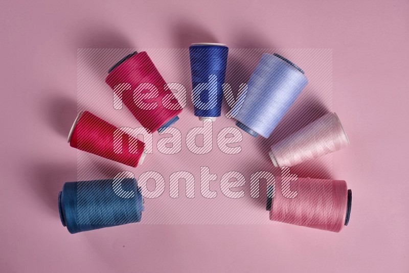 Blue sewing supplies on pink background