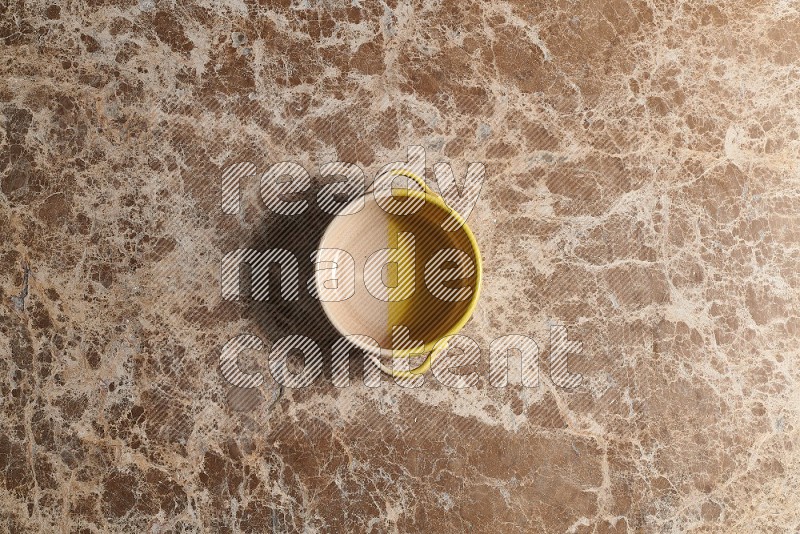 Top View Shot Of A Multicolored Pottery bowl On beige Marble Flooring