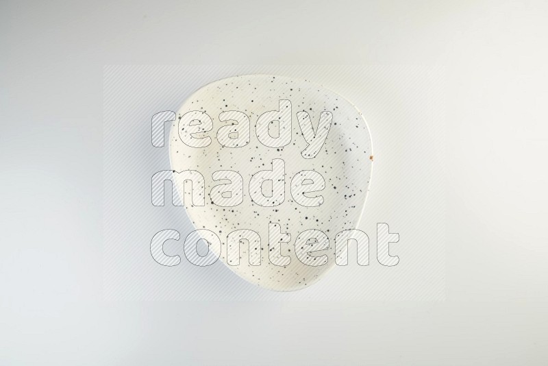 white plate with black dots on white background