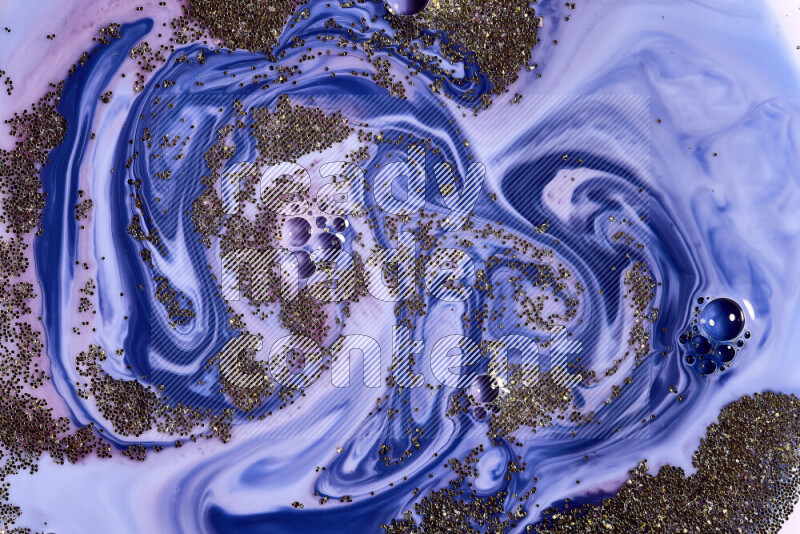 لقطة مقربة لبريق ذهبي متلألئ منتشر على خلفية من اللون الأزرق والأحمر في حركات دائرية