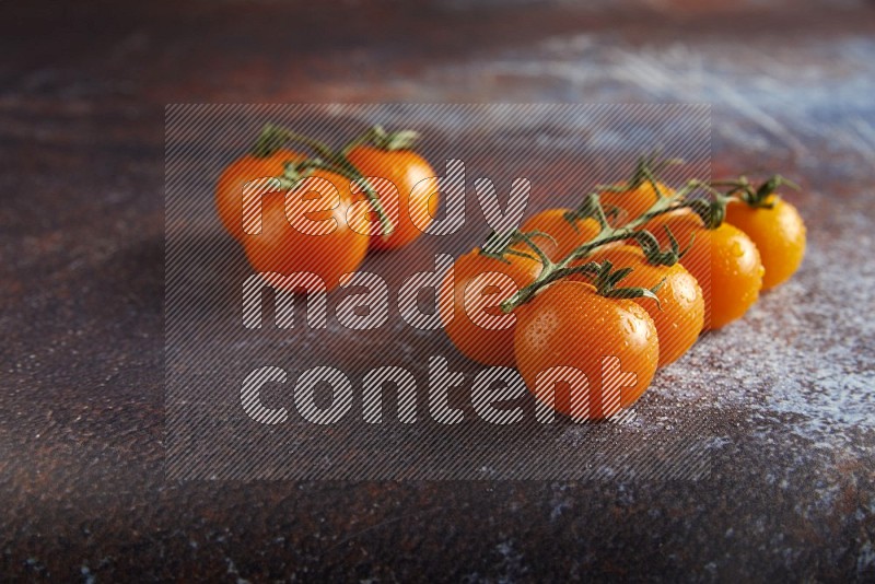 Orange cherry tomato vein on reddish rustic metal background 45 degree