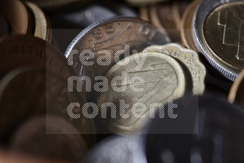 A close-ups of random old coins on black background