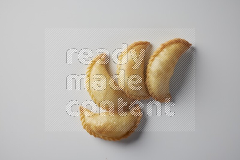 Four fried sambosa from a top angle on a white background