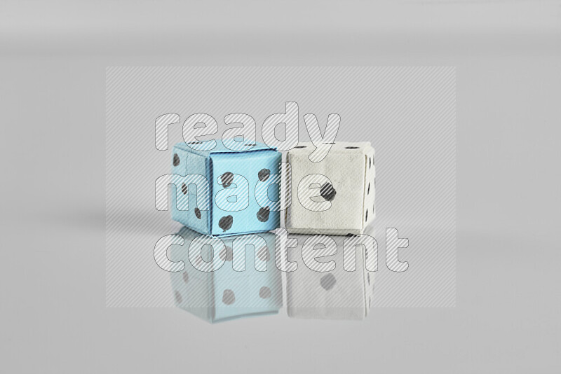 Origami dice on grey background