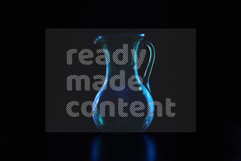 Glassware with rim light in blue against black background