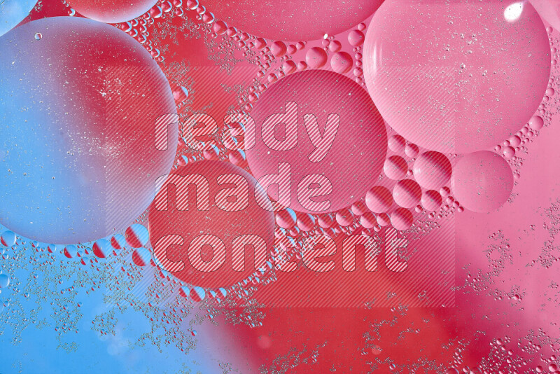 Close-ups of abstract oil bubbles on water surface in shades of blue, red and pink