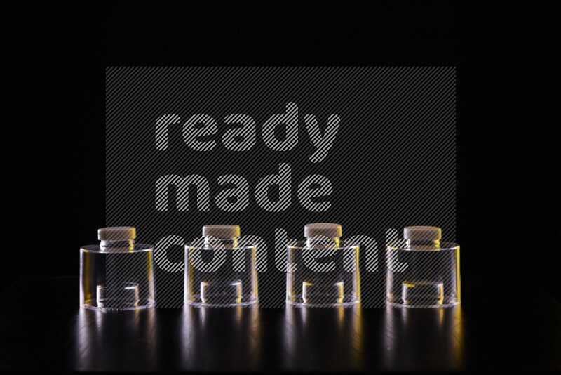 Glassware with rim light in yellow and white against black background