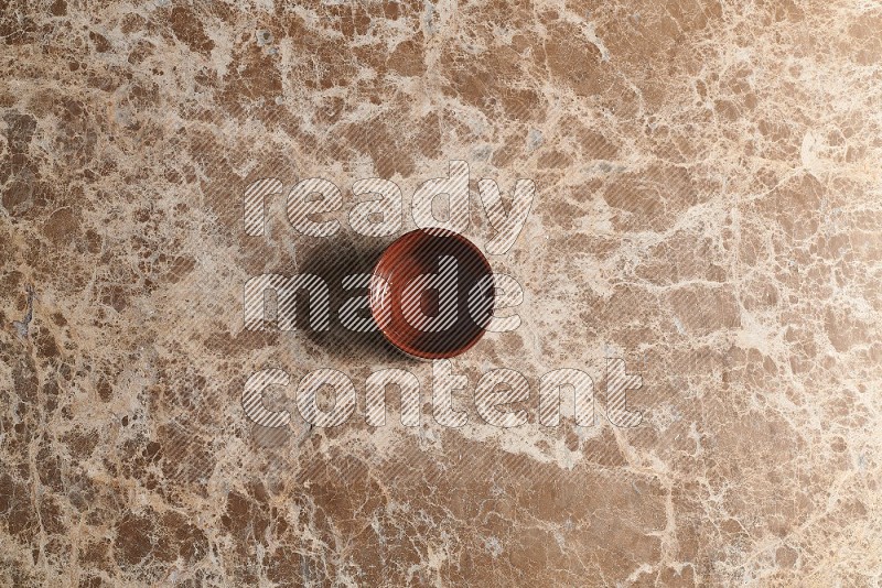 Top View Shot Of A Brown Pottery bowl On beige Marble Flooring