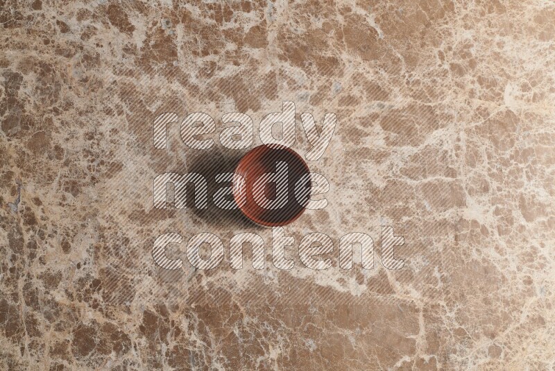 Top View Shot Of A Brown Pottery bowl On beige Marble Flooring