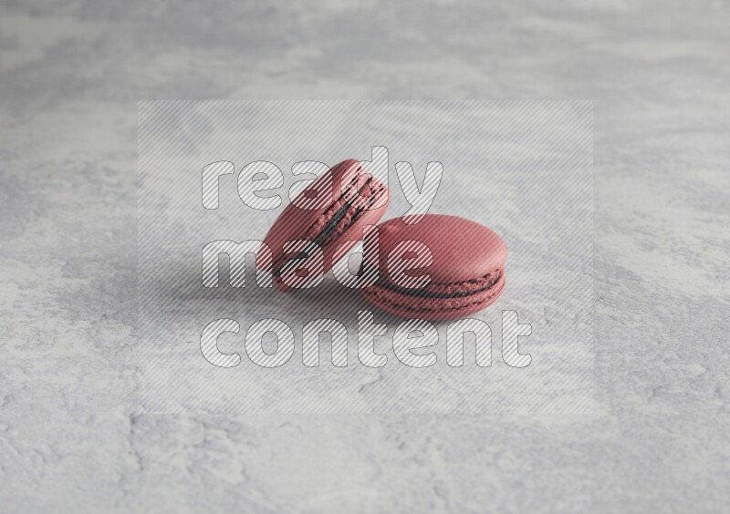 45º Shot of two Red Cherry macarons  on white  marble background