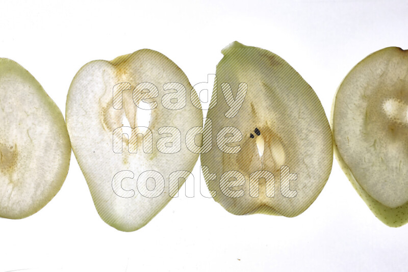 Pear slices on illuminated white background