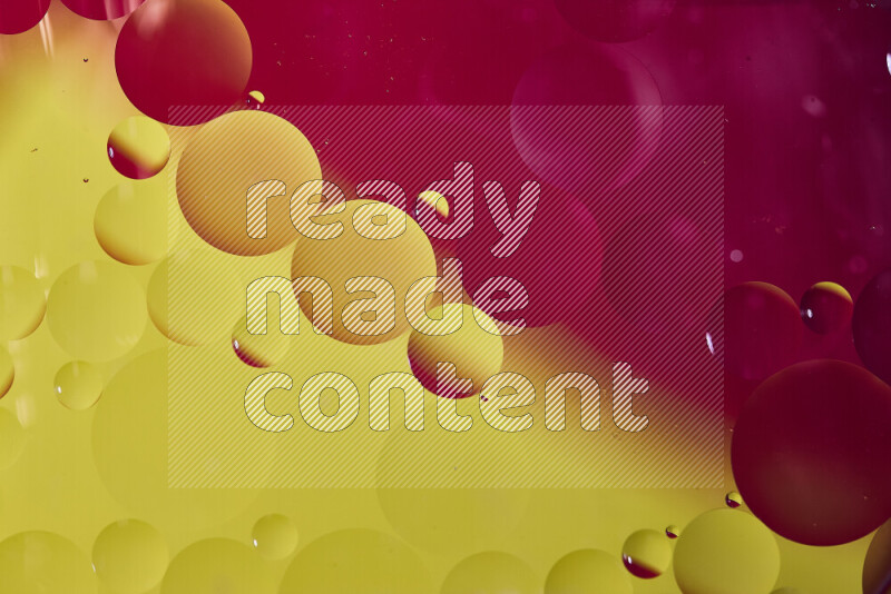 لقطات مقربة لفقاعات من الزيت على سطح الماء باللون الأحمر والأصفر