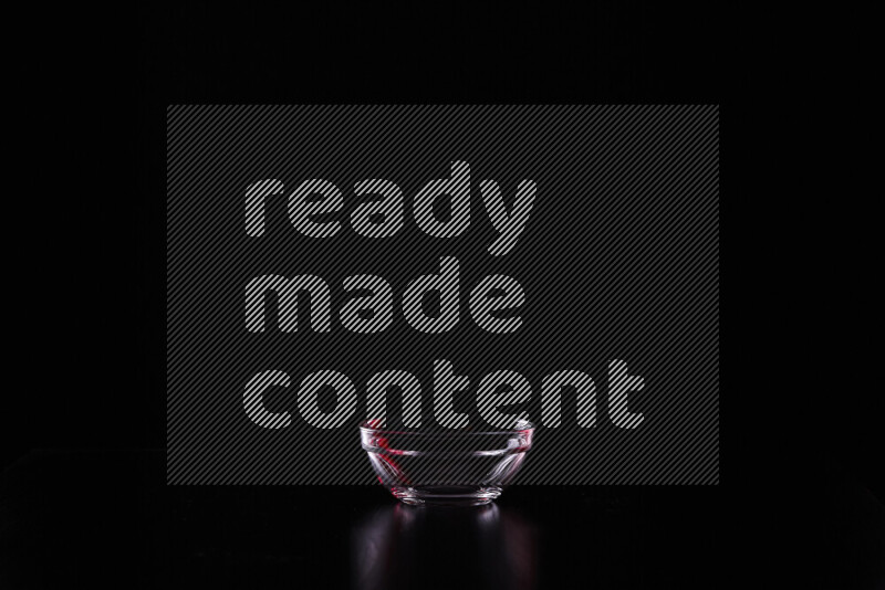 Glassware with rim light in red and white against black background