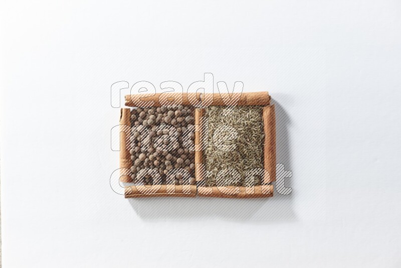 2 squares of cinnamon sticks full of allspice and cumin on white flooring