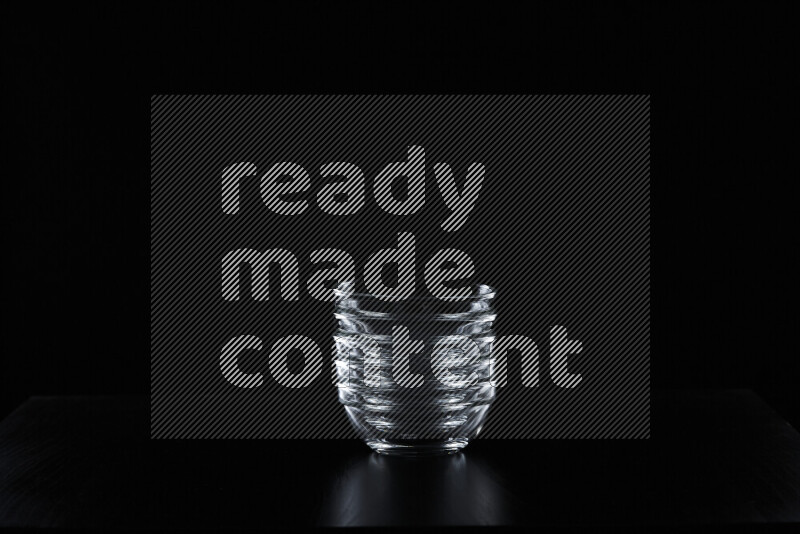 Glassware with rim light against black background