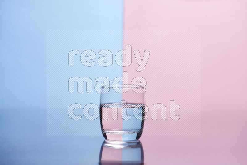 The image features a clear glassware filled with water, set against light blue and rose background