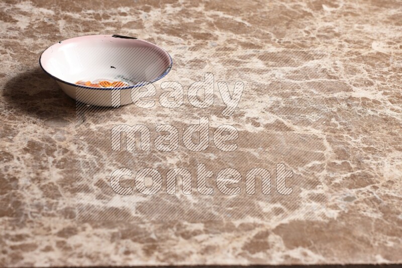A vintage metal plate on beige marble background