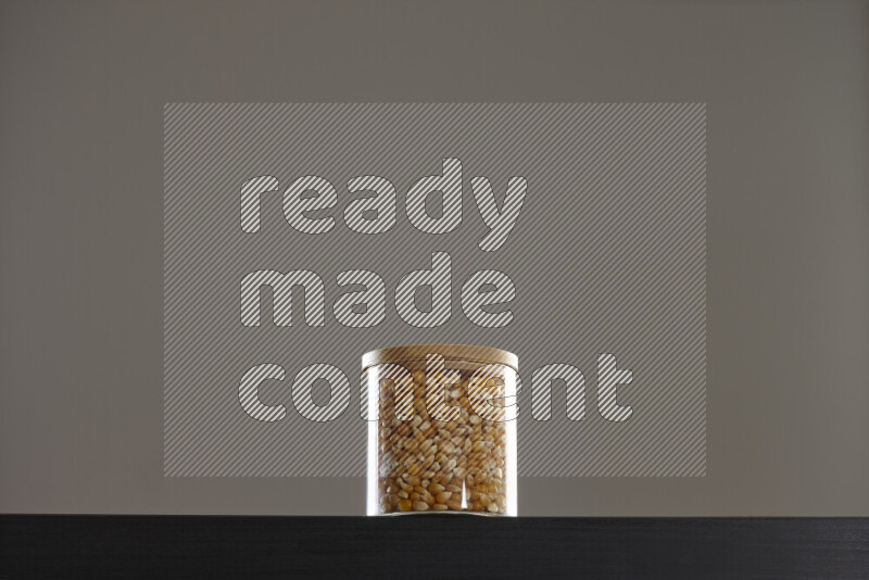 Pop corn in a glass jar on black background