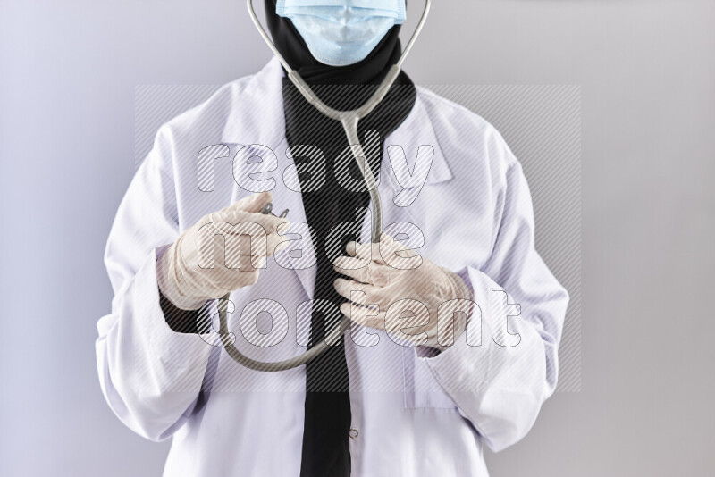 Female doctor wearing an abaya and medical attire in different positions